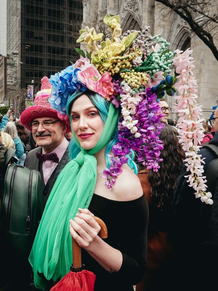 A lady with a floral bonnet posing for a street portrait during the NYC Easter Parade