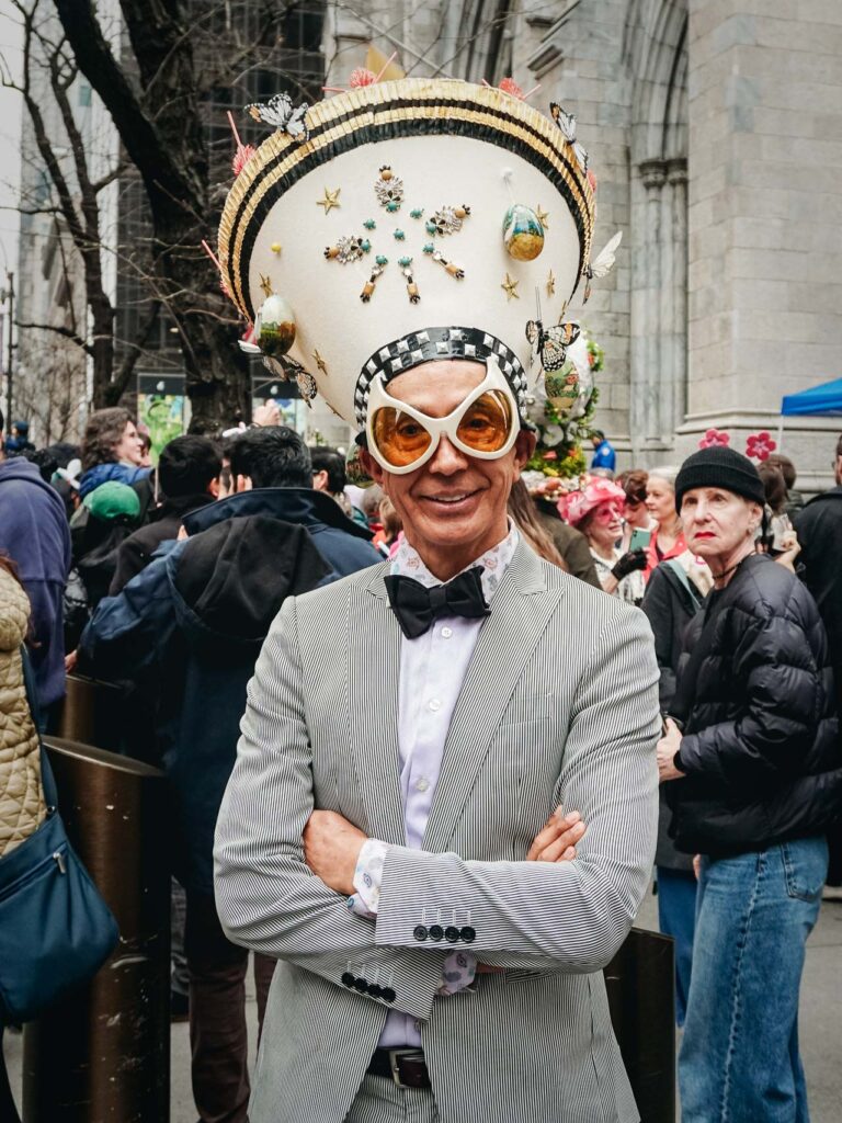 A man with a crown posing for a street portrait