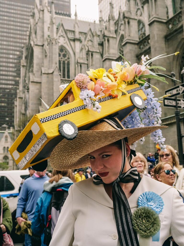 A woman with a taxi hat posing for a street photography portrait in the New York Easter Parade Bonnet Festival