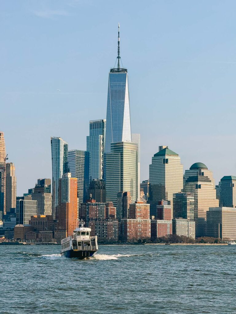 A New York City ferry and the World Trade Center in Manhattan behind it