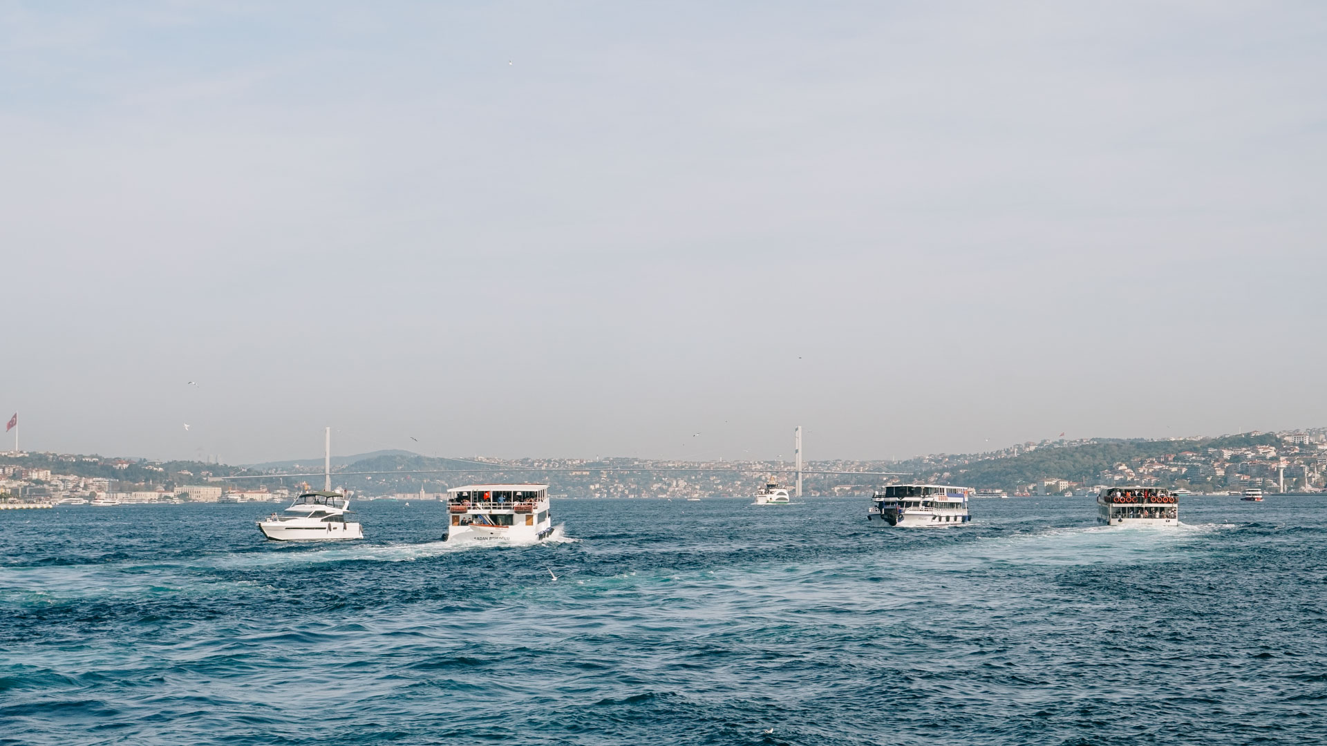 Several ferries crossing the Bosporus in Istanbul, Turkey, photographed from the water